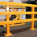Build-A-Rail Application Photo with protection in front of a scissor lift. Build-A-Rail is a great way to section off and protect machines and other sensitive equipment.