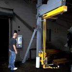 A highlighted photo of a warehouse operating using a Model 2200 rotating shrink wrap machine.