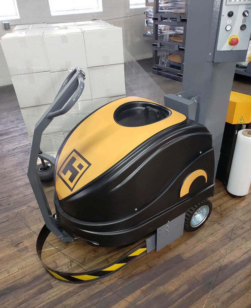 Model 3000 robotic stretch wrap machine wrapping a pallet of boxes on a warehouse floor