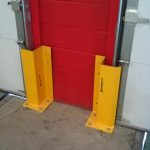 Handle It Track Guard Application between loading dock overhead doors.