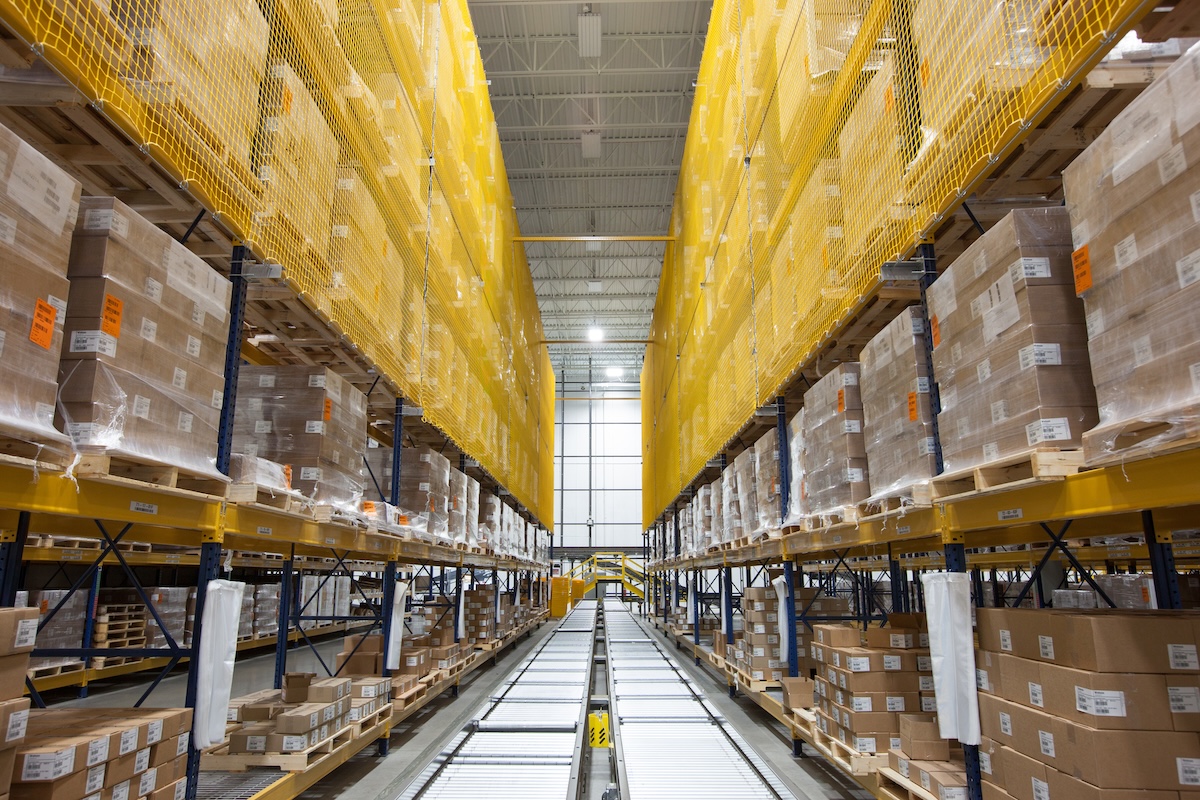feature-image Boxes on rack amidst conveyor belt at distribution warehouse